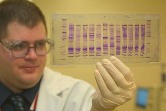 1024px-CBP_chemist_reads_a_DNA_profile